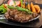 Portion of beef steak served with roast potatoes