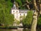 Portion of the Brantome Abbey in France captured through trees