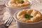 Portion cheese souffle in a white pot on a table close-up. horiz