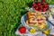 Portion of cherry cake with ripe strawberries around and few yellow blooms