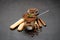 Portion of Classic tiramisu dessert in a glass cup, scoop full of coffee and cinnamon sticks on dark concrete background