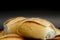 Portion of french bread on black background