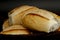 Portion of french bread on black background