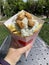 Portion of French fries with chicken and tzatziki sauce