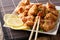 Portion fried chicken karaage with lemon and onion close-up on a