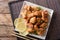 Portion fried chicken karaage with lemon and onion close-up on a