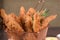 portion of fried fish, fried chicken strips inside metal basket tasty snack