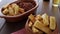 A portion of fried maniocs  Mandiocas  on a wooden table, traditional brazilian food