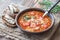 Portion of green lentil tomato soup with toasts