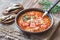 Portion of green lentil tomato soup with toasts