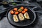 A portion of Grilled, baked pollock or coalfish fillets. Black background. Top view