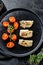 A portion of Grilled, baked pollock or coalfish fillets. Black background. Top view