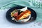 Portion of grilled salmon fish steak fillet, tuna tartar on black plate