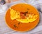 Portion of healthy omelet from lightly beaten eggs served for breakfast