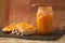 Portion of hollow bread with homemade orange marmalade and a rustic background