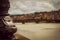 Portion of a luminaire next to the river. Panoramic view of the city of Florence unfocused.