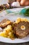 Portion of meatloaf on white plate with mashed potatoes