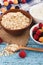 Portion of oatmeal in the bowl with berries