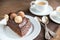 Portion of Sacher torte with two cups of coffee