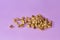 Portion of salted open pistachios on a  lilac background