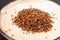 Portion of side dish in gray plate - boiled buckwheat porridge