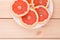 Portion of sliced grapefruit on plate.