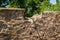 A portion of the top of a stone wall is broken