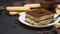 Portion of Traditional Italian Tiramisu dessert and coffee beans