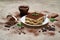 Portion of Traditional Italian Tiramisu dessert on grey concrete background