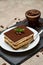 Portion of Traditional Italian Tiramisu dessert on grey concrete background