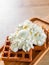Portion of Viennese wafers with cream and ice cream on wooden table