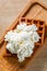 Portion of Viennese wafers with cream and ice cream on wooden table