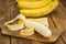 Portion of Whole Bananas on wooden background, selective focus