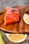 Portion of wild salmon fillet with aromatic herbs, spices, avocado and lemon- healthy breackfast, diet, omega 3 concept