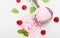 Portioned pink ice cream in iron spoon decorated with raspberry