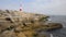 Portland Bill Lighthouse Dorset England UK with boat sailing by coast