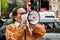 PORTLAND PLACE, LONDON, ENGLAND- 31 March 2021: Protester speaking on a megaphone at a protest against Myanmar`s military coup