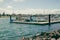 Portland, Victoria Australia - 14 November 2021: Kids riding scooters along jetty at the Port of Portland looking at boats