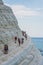 PORTO EMPEDOCLE, ITALY - AUGUST, 2015: Some tourists in the beach Scala dei Turchi, one of the most beautiful beaches in Sicily, o