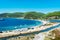 Porto Koufo, Greece, 05/07/2019: View on famous Greek bay with many recreational vehicles parked around the beach and turquoise