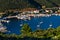 Porto Koufo harbor with a lot of anchored sailboats at sunset, west coast of Sithonia