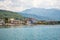 In Porto Montenegro, tourists stroll and rest on the waterfront.