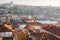 Porto panoramic landmark with boats and ferris wheel. Brick red roofs of portuguese buildings.