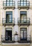 Porto, Portugal. August 12, 2017: Facade of a house on the street of the Alfandega with iron balconies and curious drawings on the