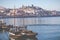 PORTO, PORTUGAL - JANUARY 18,2018: Boats carrying barrels of porto wine seen docking at river bank. Panorama View on Porto, Duoro