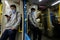 Porto, Portugal - October 15, 2020: Young man wearing a face mask traveling on the Porto subway metro looking at his smartphone