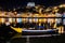 Porto, Portugal. View of the Old Town. Night cityscape. Douro river with the traditional Rabelo boats in the night the light of la