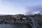 Porto view, with Dom LuÃ­s Bridge and Douro river. Sunset, blue sky and clouds. Boats on the river