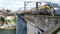 Porto yellow tram train passing on the luis 1 bridge. Side view shot