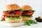 Portobello mushroom meatless burgers on a marble serving board against a white wood background